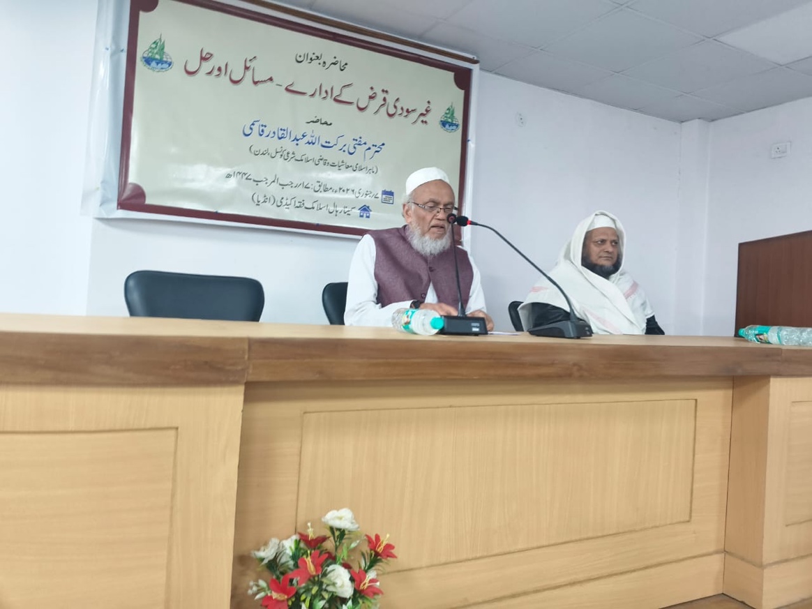 A person sitting at a podium with a microphone AI-generated content may be incorrect.